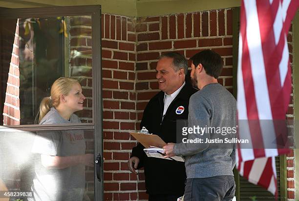 Sen. Mark Pryor speaks to a resident as he goes door-to-door campaigning on November 1, 2014 in Little Rock, Arkansas. WIth less than a week to go...