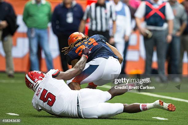 Prince-Tyson Gulley of the Syracuse Orange is brought down by Rodman Noel of the North Carolina State Wolfpack on November 1, 2014 at The Carrier...