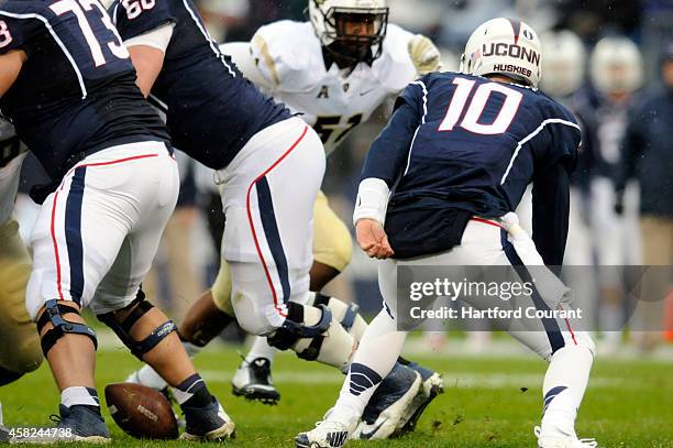 Connecicut quarterback Chandler Whitmer loses a fumbled snap during the first half against Central Florida at Rentschler Field in East Hartford,...