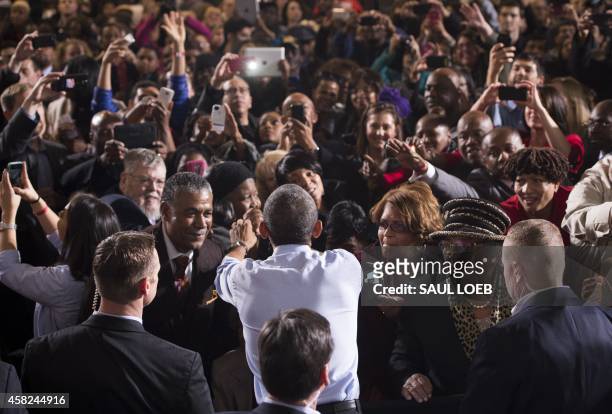 President Barack Obama greets supporters after speaking at a Democratic campaign rally for US Senate candidate Gary Peters and candidate for Michigan...