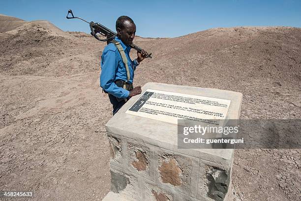 ethiopian policeman at the finding place of lucy - australopithecus stock pictures, royalty-free photos & images