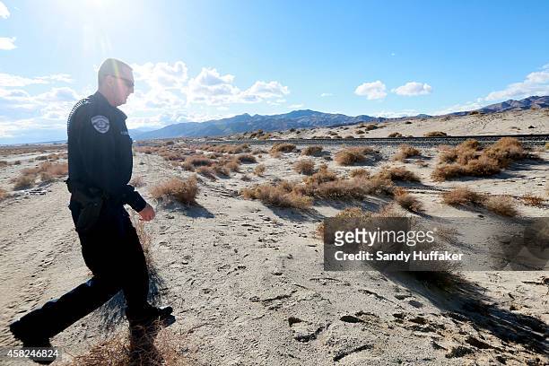 Sheriff's deputy surveys the area nea to the crash site of SpaceShipTwo out in a desert field on November 1 in Mojave, California. The Virgin...