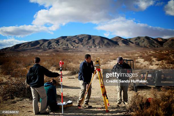 Agents from the NTSB and the FBI survey the debris from SpaceShipTwo out in a desert field near to the crash site on November 1 in Mojave,...