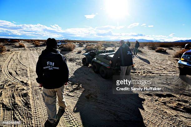 Agents from the NTSB and the FBI survey the debris from SpaceShipTwo out in a desert field near to the crash site on November 1 in Mojave,...