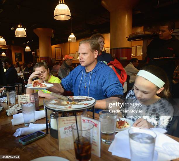 Nik Wallenda passes a slice of pizza to his wife on November 1, 2014 in Chicago, Illinois. Wallenda says it's important to do other things to take...