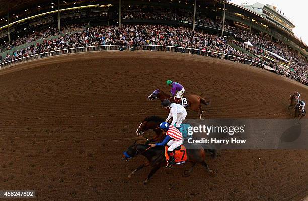 Jockey Martin Garcia atop Bayern leads jockey Victor Espinoza atop California Chrome, and jockey Jamie Spencer atop Toast of New York en route to...