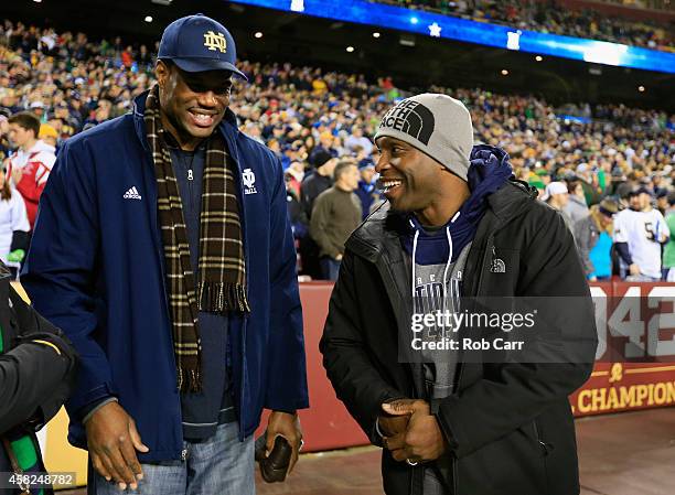 Former NBA basketball player David Robinson talks with MLB baseball player Torii Hunter before the start of the Notre Dame Fighting Irish and Navy...