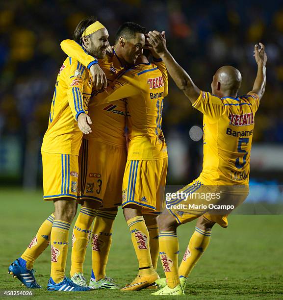 Anselmo Vendrechovski 'Juninho' of Tigres celebrates with teammates after scoring his team's first goal during a match between Tigres UANL v...