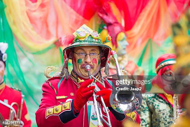 musician marching in red costume at carnival parade of maastricht - carneval stock pictures, royalty-free photos & images