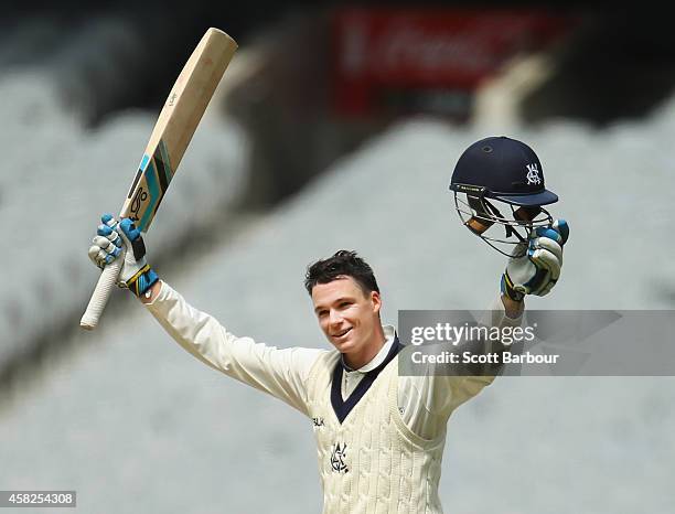 Peter Handscomb of Victoria celebrates as he reaches his century during day three of the Sheffield Shield match between Victoria and New South Wales...