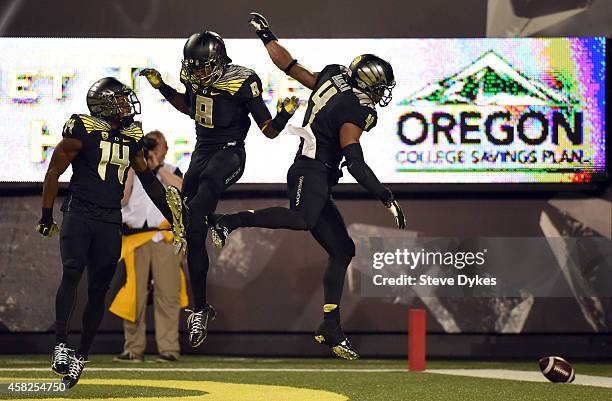 Defensive back Ifo Ekpre-Olomu, defensive back Reggie Daniels and defensive back Erick Dargan of the Oregon Ducks celebrate Dargan's interception...