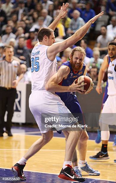 Luke Schenscher of the 36ers tries to get past Alex Pledger of the Breakers during the round four NBL match between the Adelaide 36ers and the New...