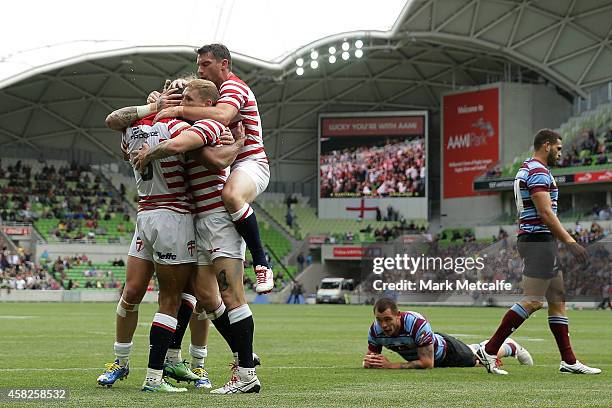 Kallum Watkins of England is congratulated by team mates after scoring a try during the Four Nations match between the Australian Kangaroos and...