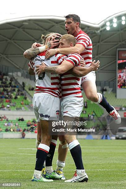 Kallum Watkins of England is congratulated by team mates after scoring a try during the Four Nations match between the Australian Kangaroos and...