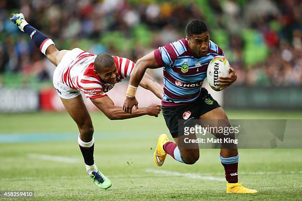 Michael Jennings of Australia evades the tackle of Kallum Watkins of England during the Four Nations match between the Australian Kangaroos and...