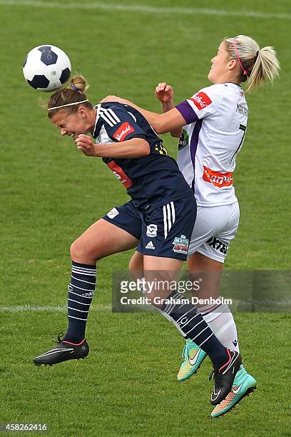 Amy Jackson of the Victory heads the ball under pressure from Gabrielle Marzano of the Glory during the round eight W-League match between Melbourne...