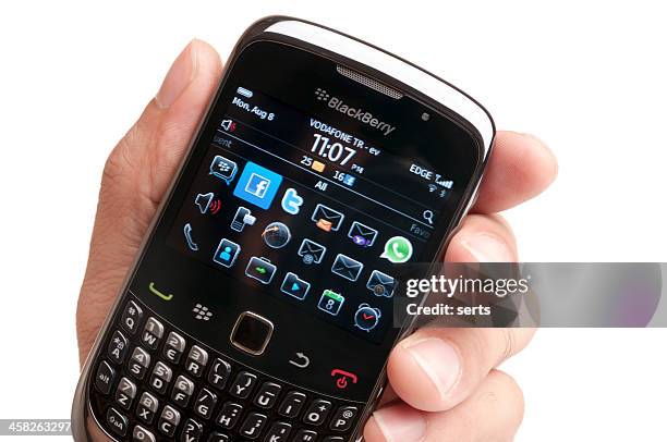 blackberry smartphone on hand - blackberry stock pictures, royalty-free photos & images