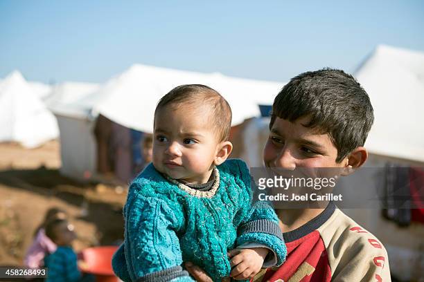 syrian refugees at displaced persons camp - refugee camp stock pictures, royalty-free photos & images