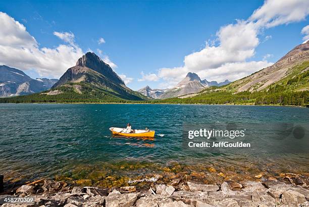 rowing on swiftcurrent lake - glacier county montana stockfoto's en -beelden