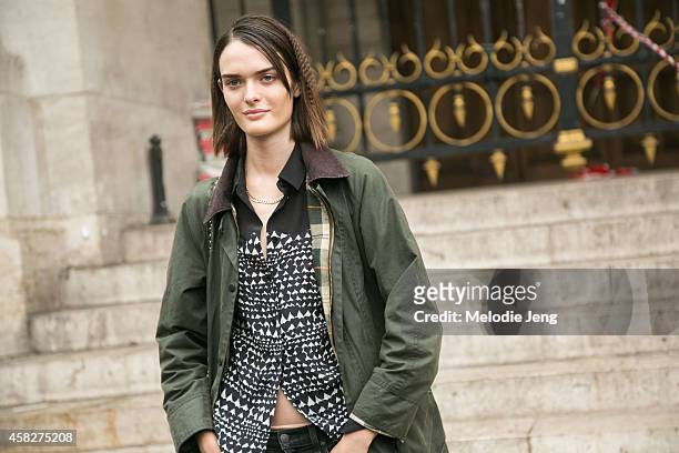 British model Sam Rollinson exits the Stella McCartney show in a Barbour jacket and crimped hair by Eugene Souleiman at Palais Garnier on Day 7 of...