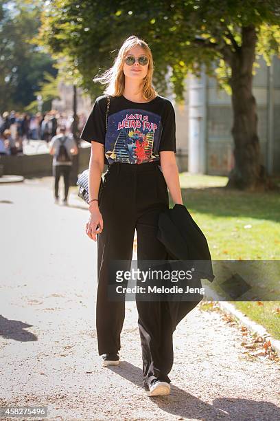 Top Swedish model Frida Gustavsson walks by the Grand Palais museum in a Balenciaga t-shirt and Chanel purse on Day 5 of Paris Fashion Week...