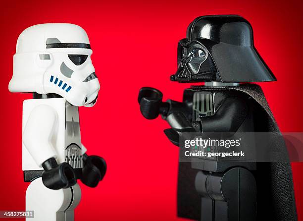 darth vader lego figurine commanding a stormtrooper - cruelity stock pictures, royalty-free photos & images