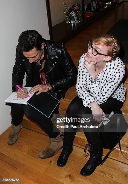 Jamie Hince of the Rock Band Kills signs for fans copies of his new book "Echo Home" at BookMarc on November 1, 2014 in Los Angeles, California.