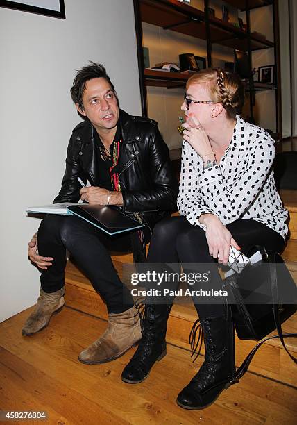 Jamie Hince of the Rock Band Kills signs for fans copies of his new book "Echo Home" at BookMarc on November 1, 2014 in Los Angeles, California.