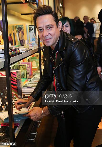 Jamie Hince of the Rock Band Kills signs for fans copies of his new book "Echo Home" at BookMarc on November 1, 2014 in Los Angeles, California.