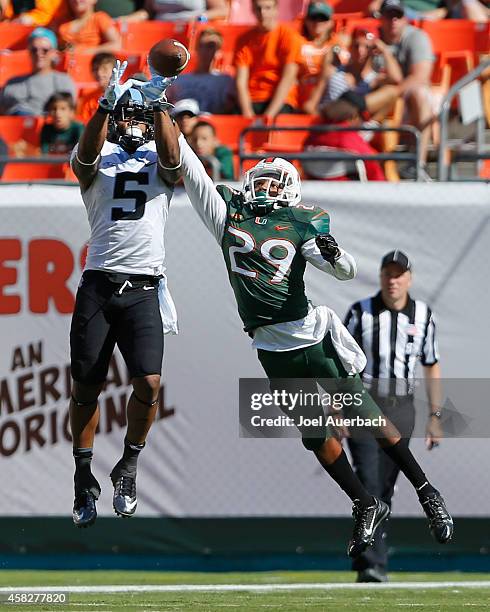 Thorpe of the North Carolina Tar Heels catches the ball while being defended by Corn Elder of the Miami Hurricanes on November 1, 2014 at Sun Life...