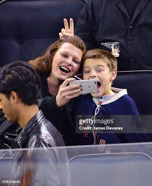 Linda Evangelista and son Augustin James Evangelista attend New York Rangers vs Winnipeg Jets at Madison Square Garden on November 1, 2014 in New...