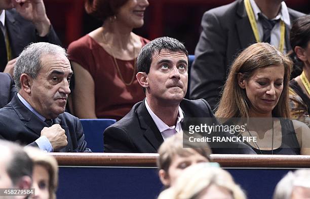 President Président Jean Gachassin, French Prime Minister Manuel Valls and his wife Anne Gravoin watch the final match between Serbia's Novak...