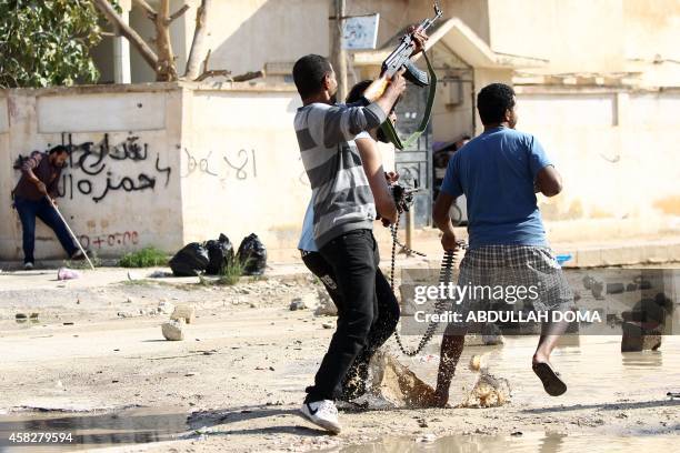 Armed civilians clash with Islamist militiamen in the al-Lithi area of Libya's eastern coastal city of Benghazi on November 2, 2014 after they...