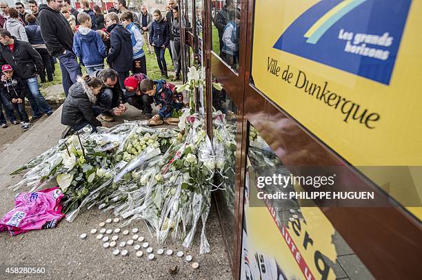 Mourners light candles at the gate of the ice rink stadium the day after a child was killed while watching an ice hockey match in Dunkirk on November...