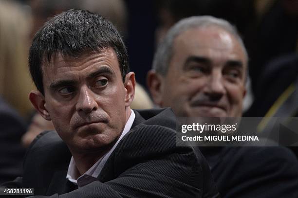 President Président Jean Gachassin and French Prime Minister Manuel Valls watch the final match between Serbia's Novak Djokovic and Canada's Milos...