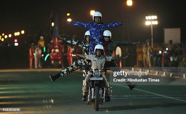 Women personnel perform acrobats on a bike during the CRPF's Diamond Jubilee year celebration 'Desh Ke Hain Hum Rakshak' at India Gate, on November...