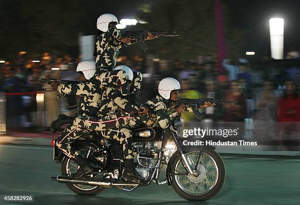 Women personnel perform acrobats on a bike during the CRPF's Diamond Jubilee year celebration 'Desh Ke Hain Hum Rakshak' at India Gate, on November...