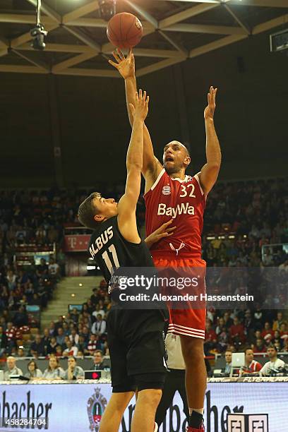 Yassin Idbihi of Muenchen is challenged by Julian Albus of Tuebingen during the Beko Basketball Bundesliga match between FC Bayern Muenchen and...