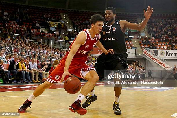 Nihad Dedovic of Muenchen is challenged by Michael Cuffee of Tuebingen during the Beko Basketball Bundesliga match between FC Bayern Muenchen and...