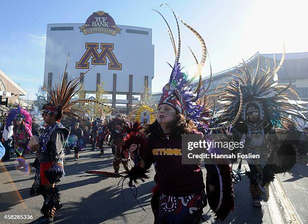 People march to TCF Bank Stadium to protest against the mascot for the Washington Redskins before the game against the Minnesota Vikings on November...