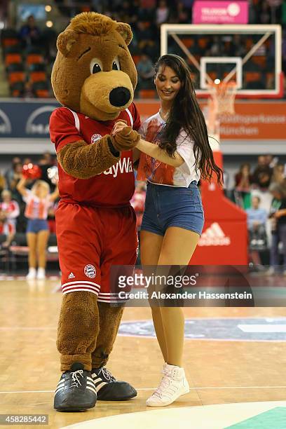 Mascot Bernie of Muenchen jokes with a cheerleader during the Beko Basketball Bundesliga match between FC Bayern Muenchen and WALTER Tigers Tuebingen...