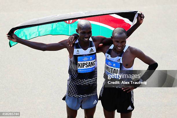 Wilson Kipsang of Kenya celebrates after crossing the finish line to win the Pro Men's division alongside Geoffrey Mutai of Kenya during the 2014 TCS...