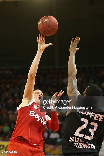 Robin Benzing of Muenchen is challenged by Michael Cuffee of Tuebingen during the Beko Basketball Bundesliga match between FC Bayern Muenchen and...