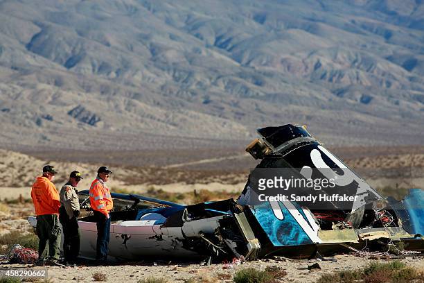 Sheriff's deputies inspect the wreckage of the Virgin Galactic SpaceShip 2 in a desert field November 2, 2014 north of Mojave, California on The...