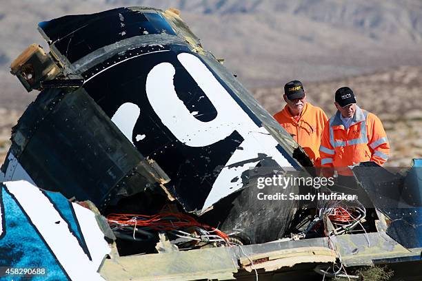 Sheriff's deputies inspect the wreckage of the Virgin Galactic SpaceShip 2 in a desert field November 2, 2014 north of Mojave, California on The...