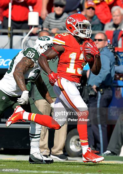 De'Anthony Thomas of the Kansas City Chiefs runs the ball against Kyle Wilson of the New York Jets during the first half at Arrowhead Stadium on...