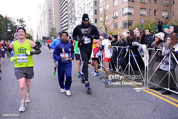 Former NBA player Dikembe Mutombo runs the last leg of the race during the 2014 NBA All-Star Relay at the TSC New York City Marathon on November 2,...