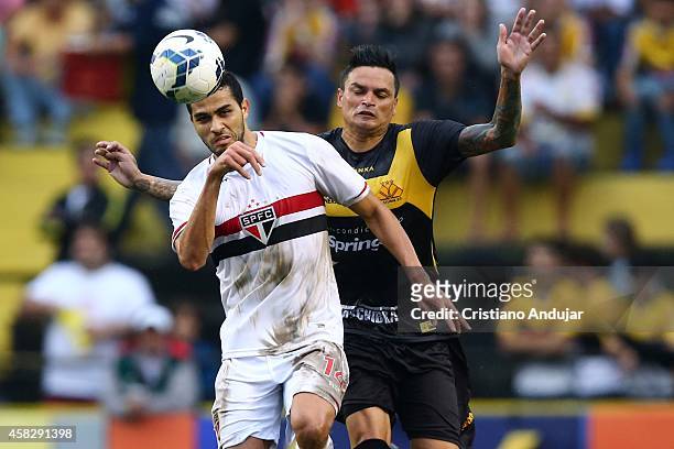 Alan Kardec of Sao Paulo take the ball before Fabio Ferreira of Criciuma during a match between Criciuma and Sao Paulo as part of Campeonato...