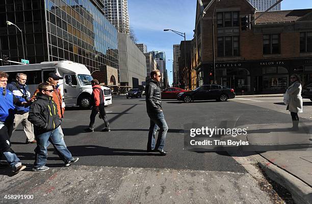 Nik Wallenda walks to the television production office in the hours before his record-breaking high wire walk at on November 2, 2014 in Chicago,...