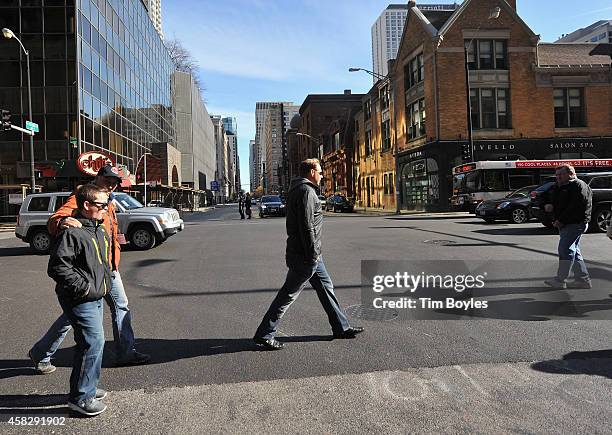 Nik Wallenda walks to the television production office in the hours before his record-breaking high wire walk at on November 2, 2014 in Chicago,...